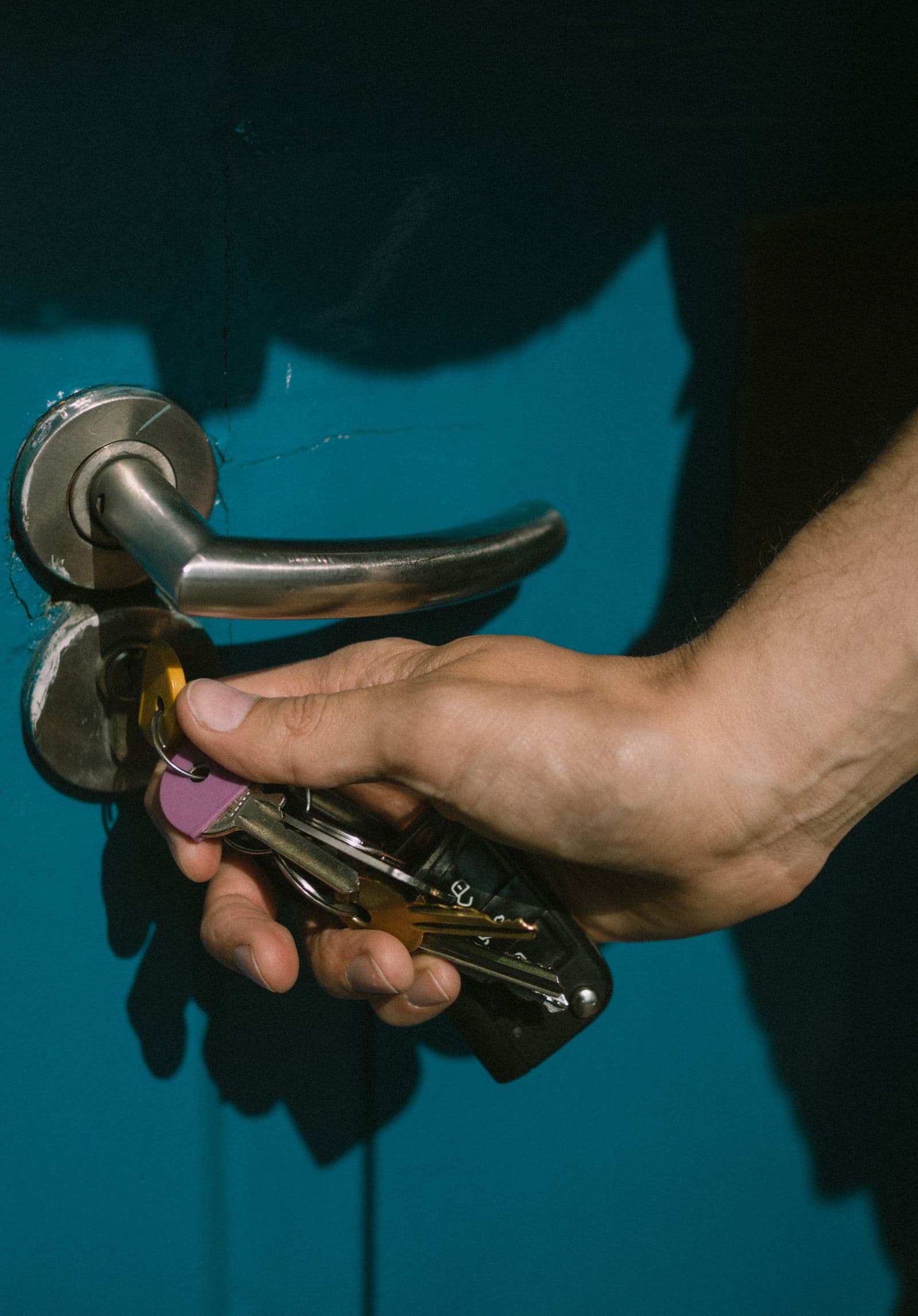 Locksmith rekeying a residential door lock with a set of keys in Waco, TX